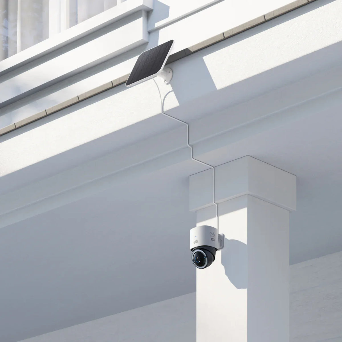 Outdoor solar camera mounted under a home eave