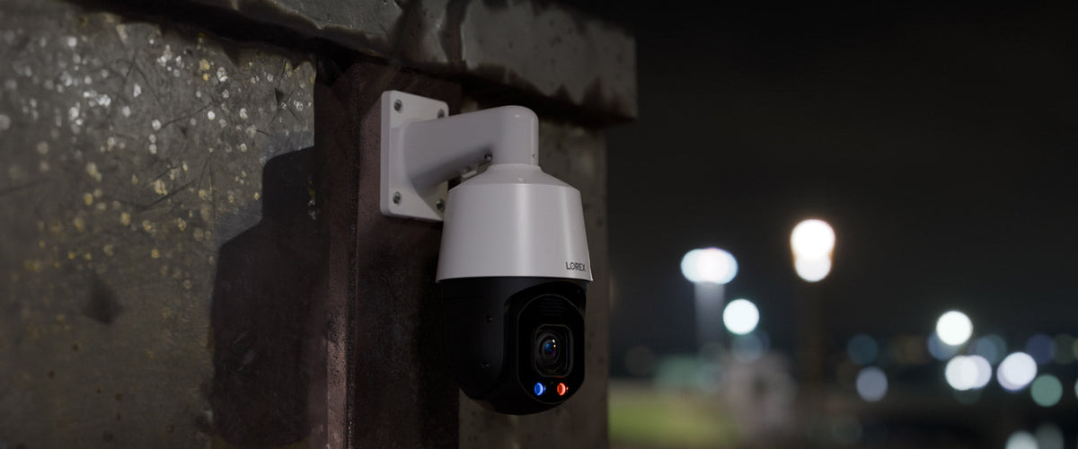 Lorex CNX01P PTZ camera mounted under a commercial structure at night